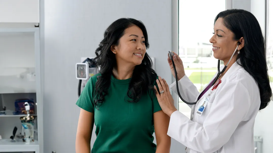 Primary Care Plus Provider with patient in clinic