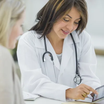 A woman reviews her test results with her doctor.