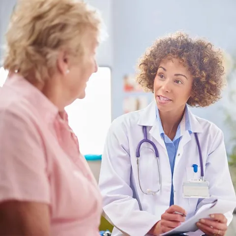Female doctor with elderly patient
