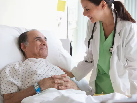 An older man in a hospital bed.