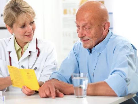 A man discusses his condition with his doctor.