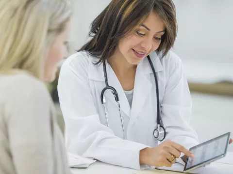 A woman reviews her test results with her doctor.