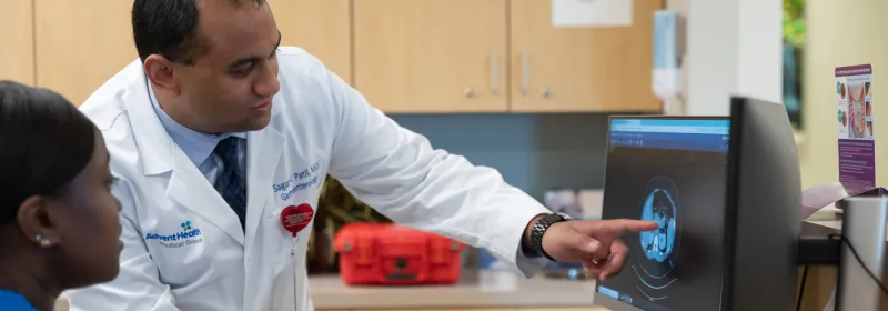A Doctor Speaks to an Employee at the Reception Desk about Imaging