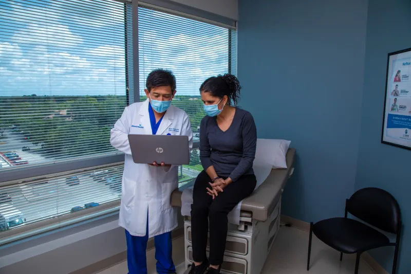 Dr. Sucandy showing a patient slides on his computer